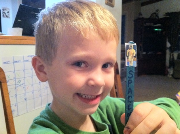 5yo and the Spaceman 5 yo shoing a spaceman on a popsicle stick