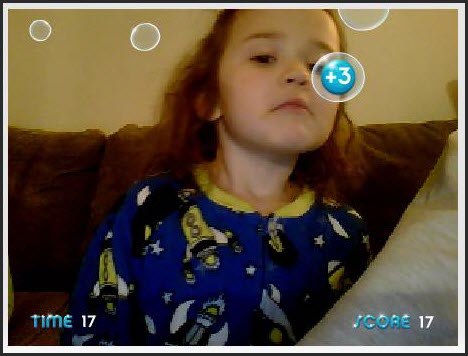 A picture of a student popping bubbles with her nose