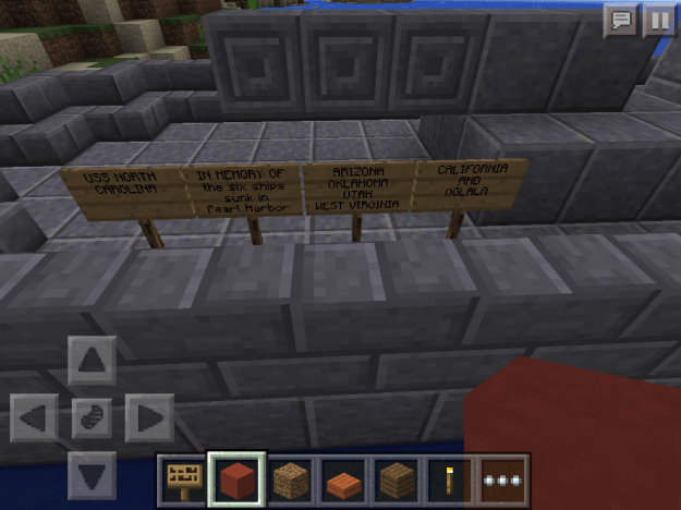 Signs made in Minecraft listing all six ships that were sunk at Pearl Harbor